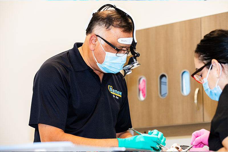 Doctor performing dental procedure with patient